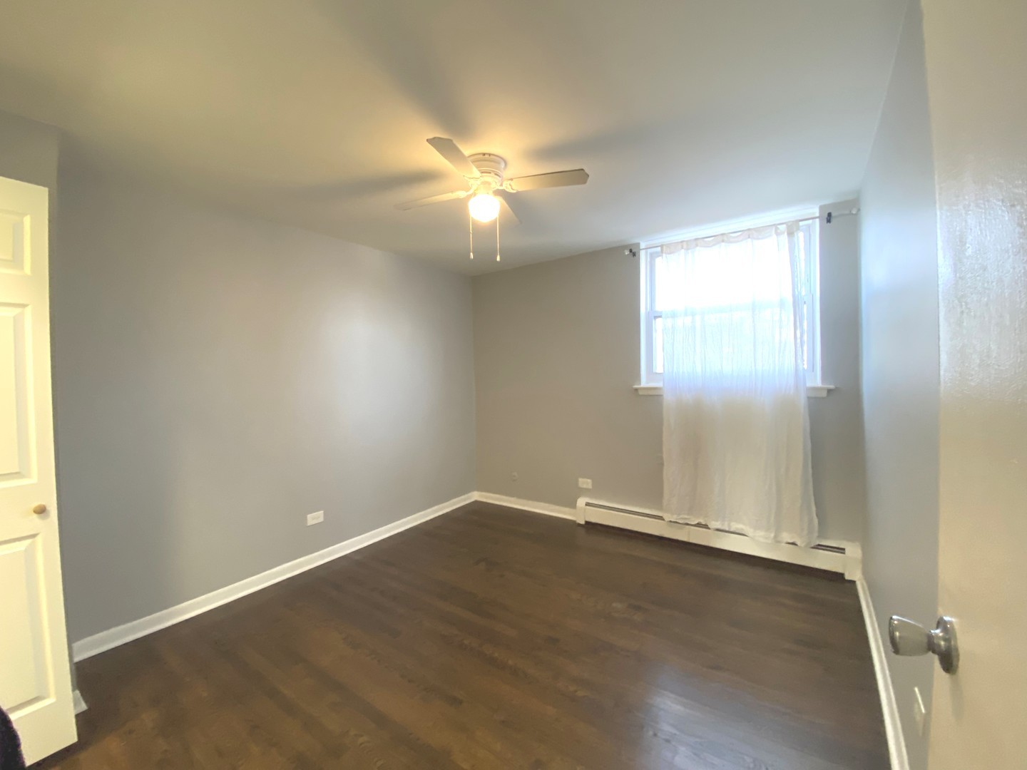 5815 North Spaulding Avenue, Unit 2C Chicago, IL 60659 - Photo 13 of 20 an empty room with wooden floor and windows