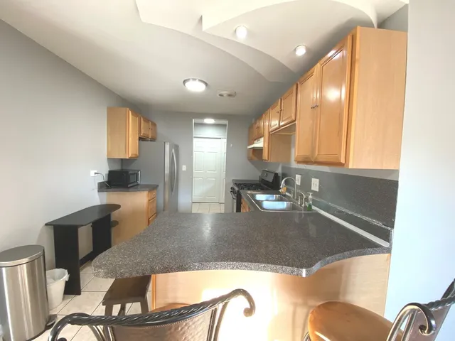 a view of a hallway with closet and bathroom