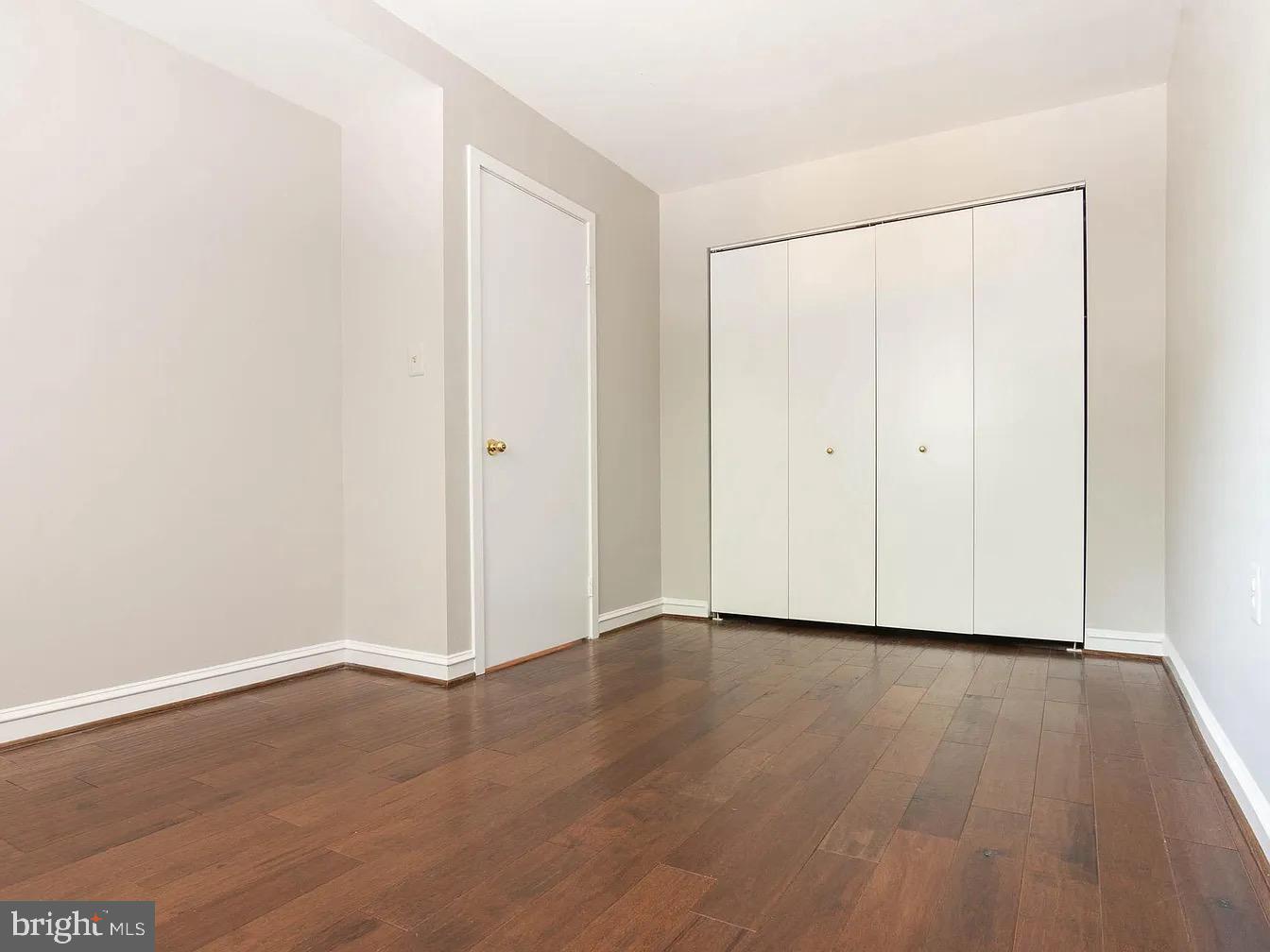 16 Andrew Place Baltimore, MD 21201 - Photo 11 of 17 a view of an empty room with wooden floor