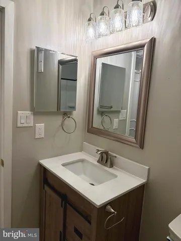 a bathroom with a sink vanity and mirror