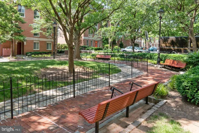 a view of a park with iron fence