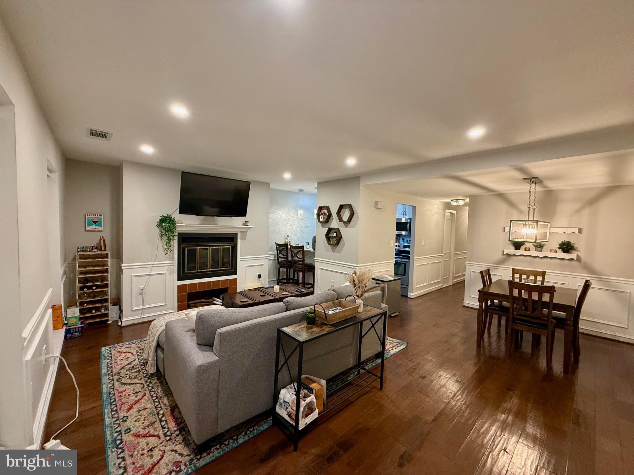 16 Andrew Place Baltimore, MD 21201 - Photo 5 of 17 a living room with fireplace furniture and a wooden floor