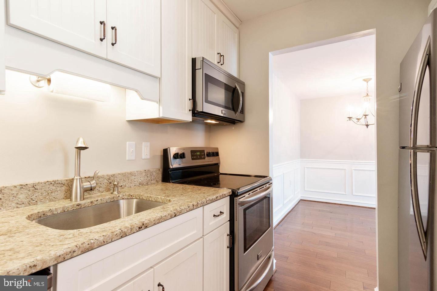 16 Andrew Place Baltimore, MD 21201 - Photo 6 of 17 a kitchen with stainless steel appliances granite countertop a sink and a stove