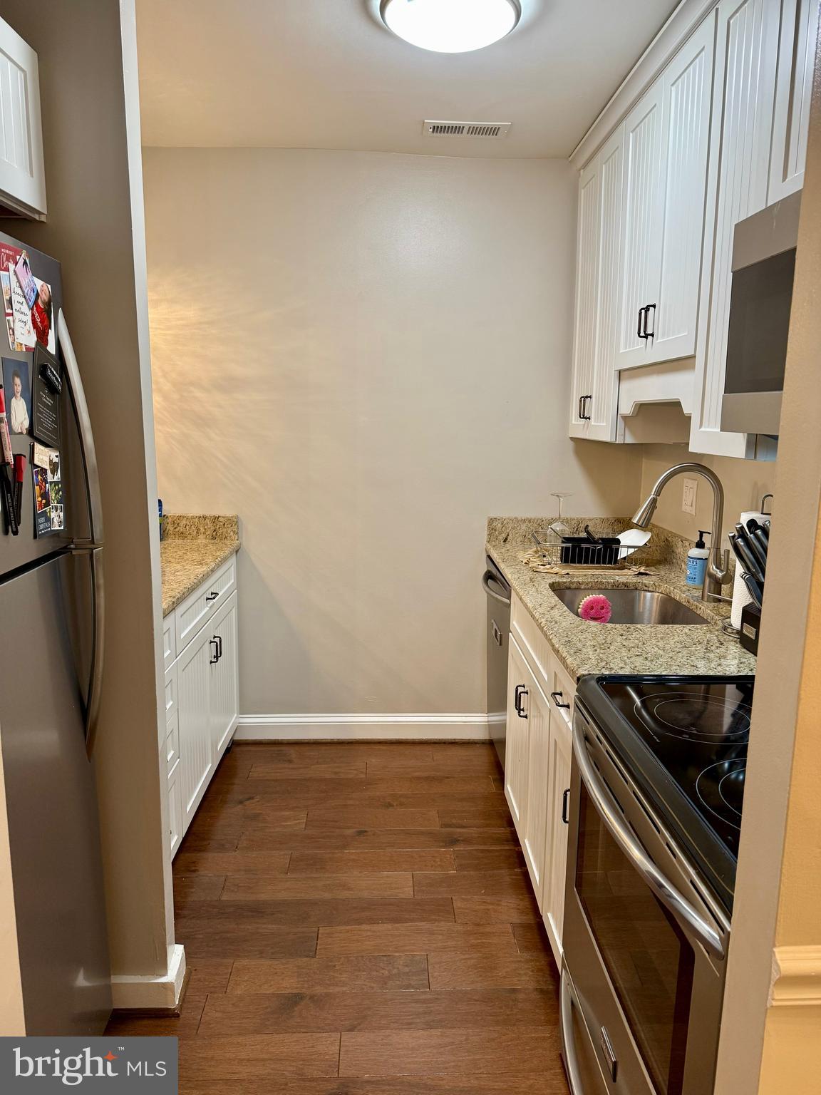 16 Andrew Place Baltimore, MD 21201 - Photo 8 of 17 a kitchen with stainless steel appliances a stove a sink and a refrigerator