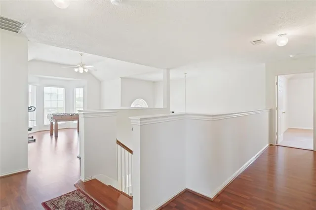 a view of a kitchen with furniture and wooden floor
