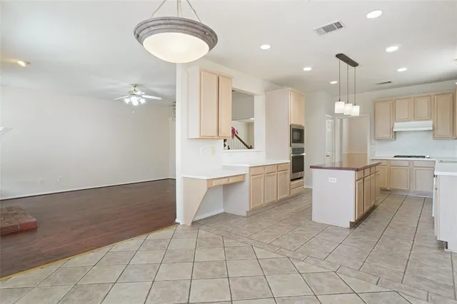 a large kitchen with white cabinets and a sink