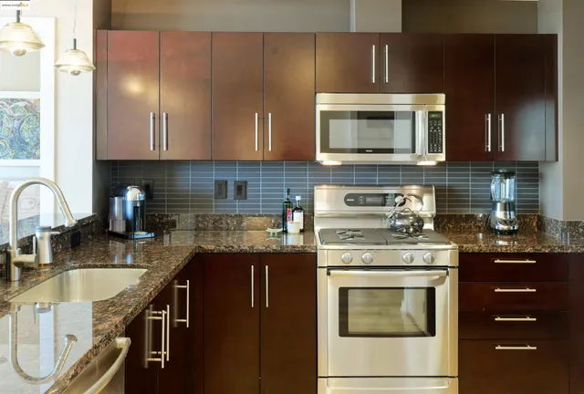 a bathroom with a granite countertop sink a mirror and a bathtub