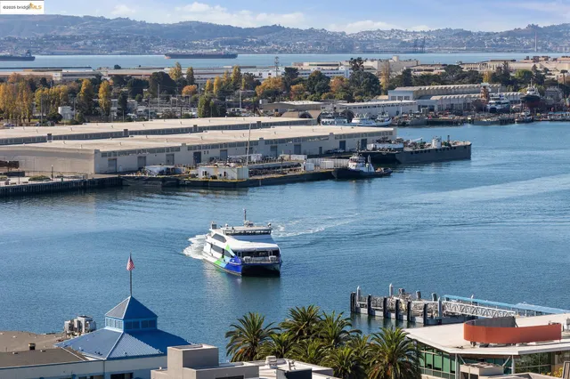 a kitchen with stainless steel appliances granite countertop a sink a stove and a wooden floor