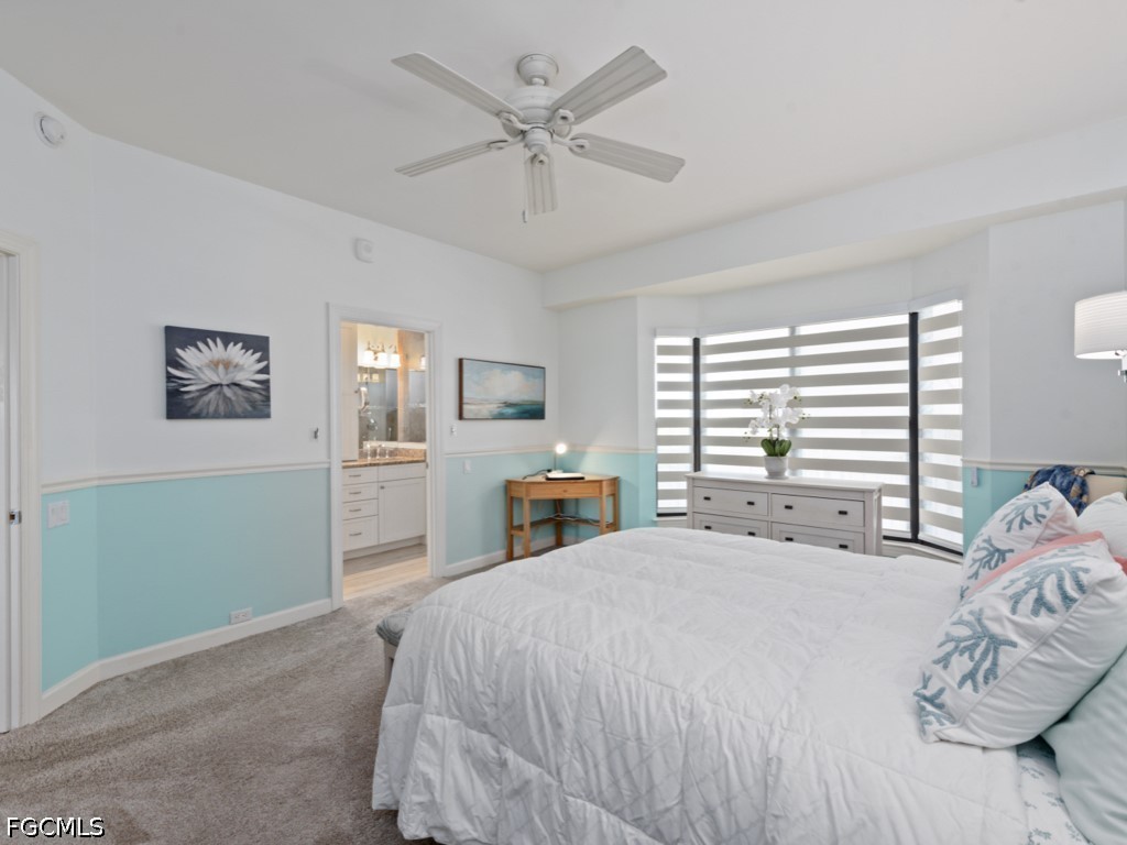 232 La Peninsula Boulevard, Unit 232 Naples, FL 34113 - Photo 19 of 44 a large bedroom with a bed and a window