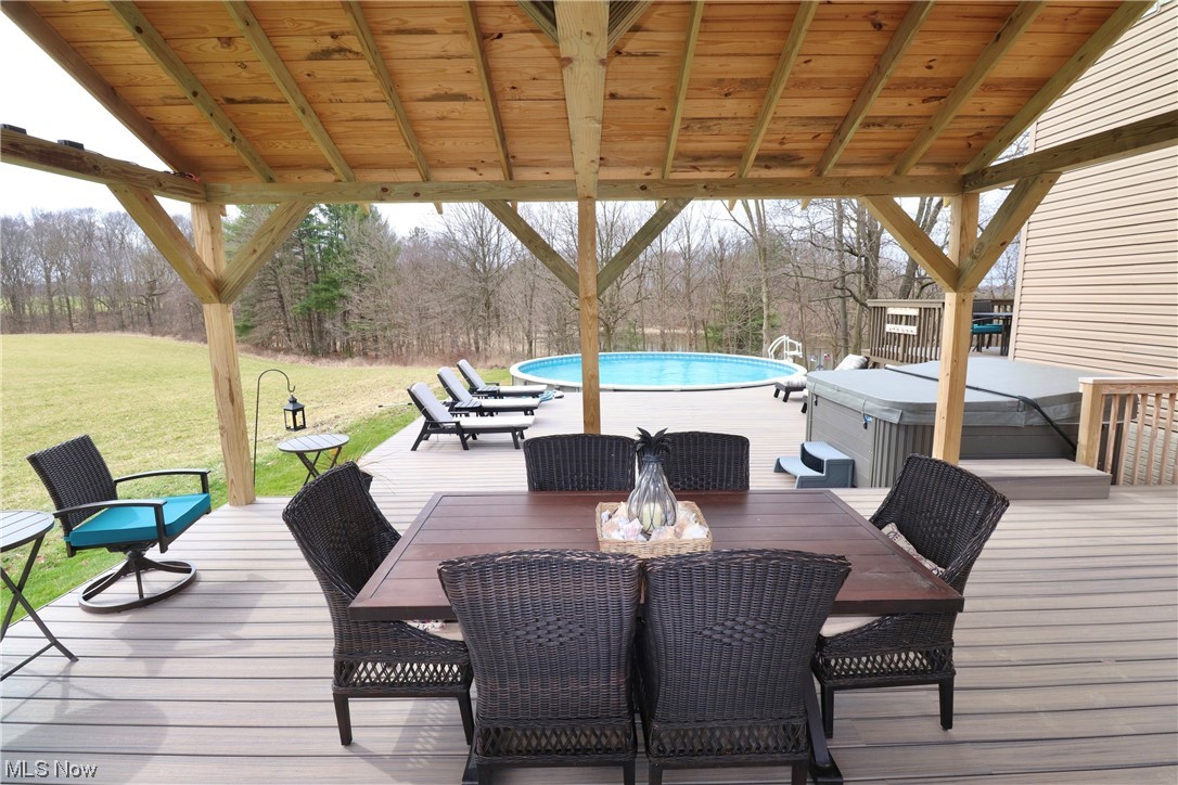 10582 Irvin Road Creston, OH 44217 - Photo 38 of 47 Wooden terrace with a hot tub, a gazebo, and lawn