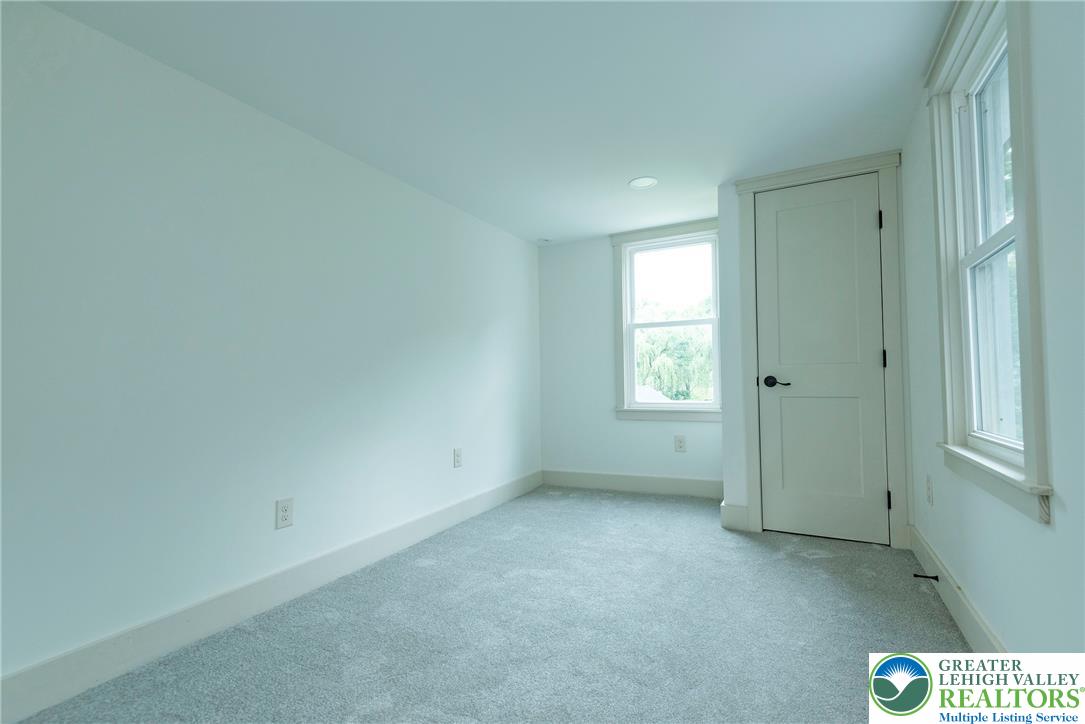 72 Allegheny Road Mount Bethel, PA 18343 - Photo 35 of 72 A well-lit bedroom features plush carpeting and multiple windows for abundant natural illumination.