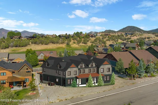 an aerial view of houses with a lake