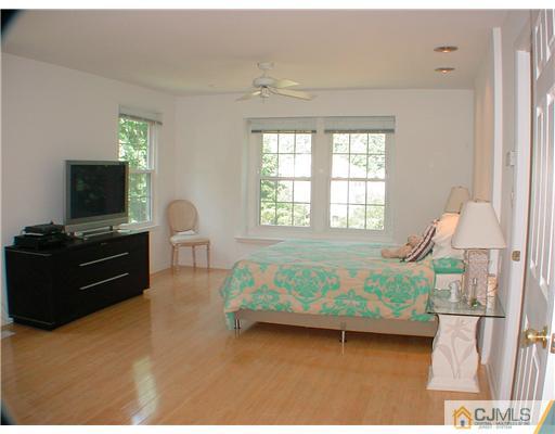 4507 Stonehedge Road Edison, NJ 08820 - Photo 7 of 10 a bedroom with a bed and a tv