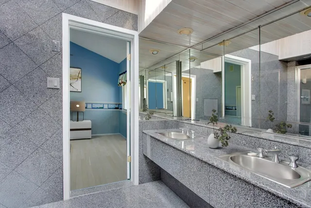 a bathroom with a shower sink and mirror