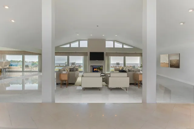 a view of living room kitchen with furniture and fireplace