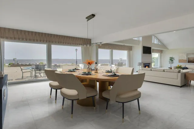 a dining room with furniture and a large window