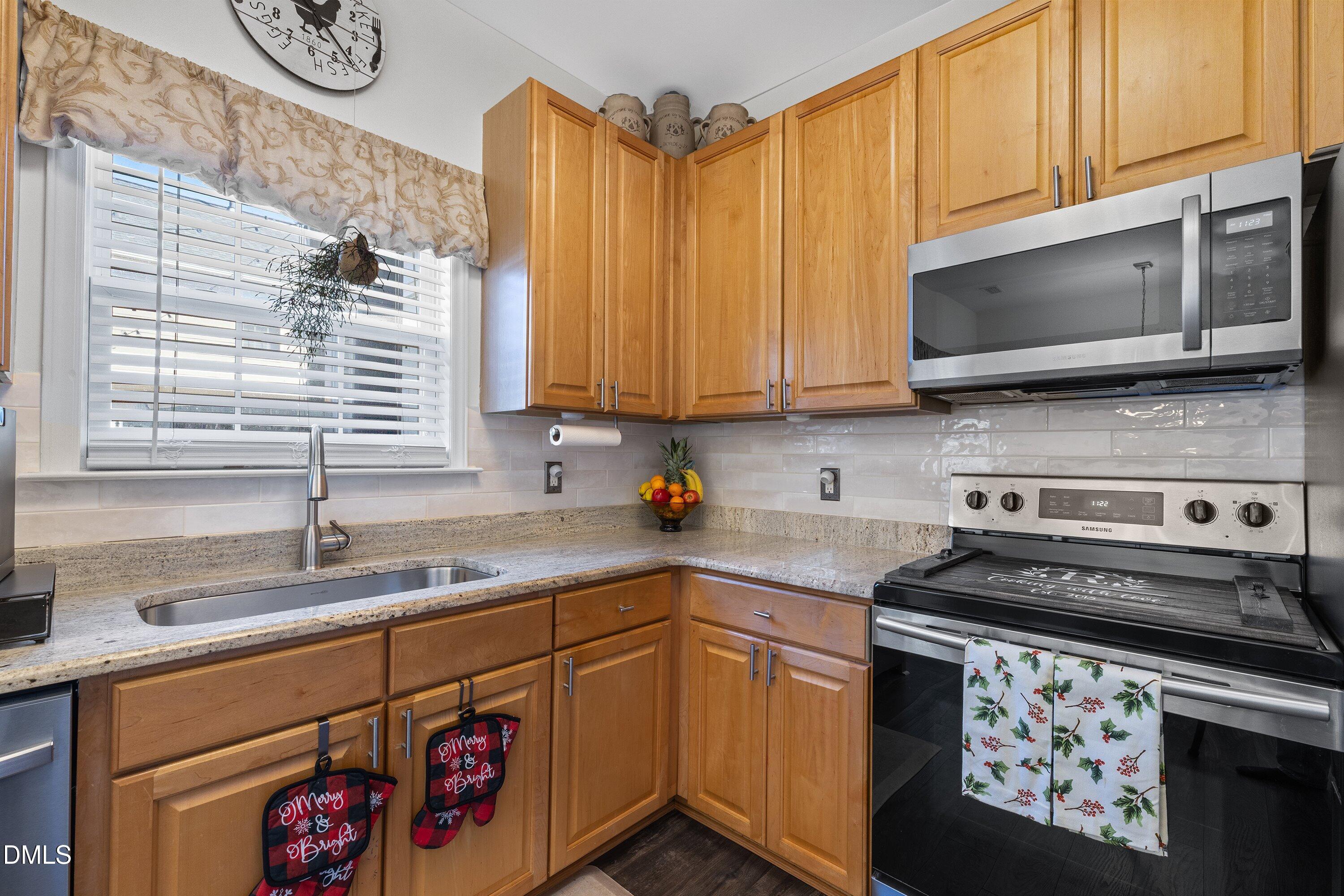 201 Dairy Road Clayton, NC 27520 - Photo 13 of 31 a kitchen with stainless steel appliances a stove a sink and a microwave