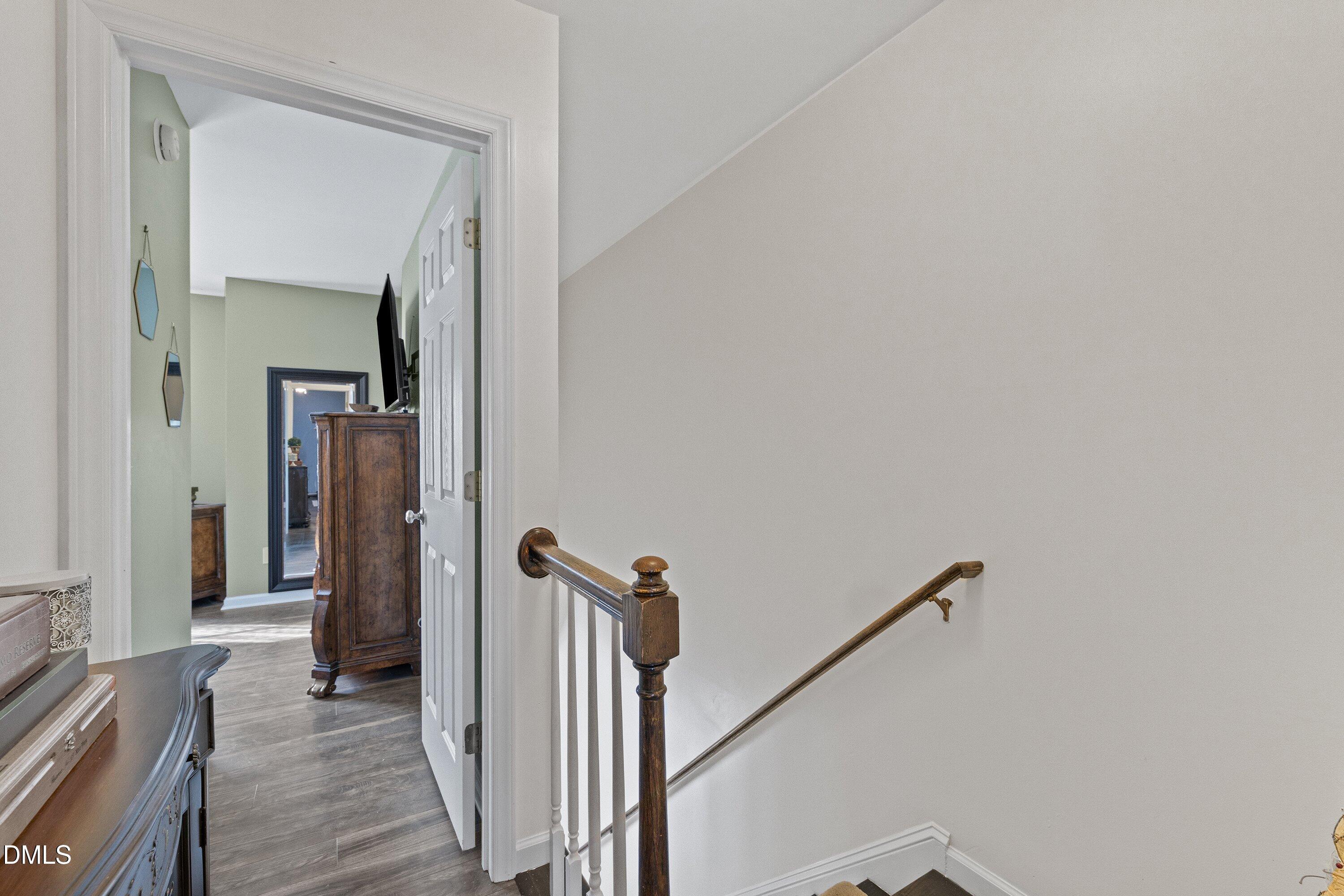 201 Dairy Road Clayton, NC 27520 - Photo 20 of 31 a view of a hallway with wooden floor and stairs