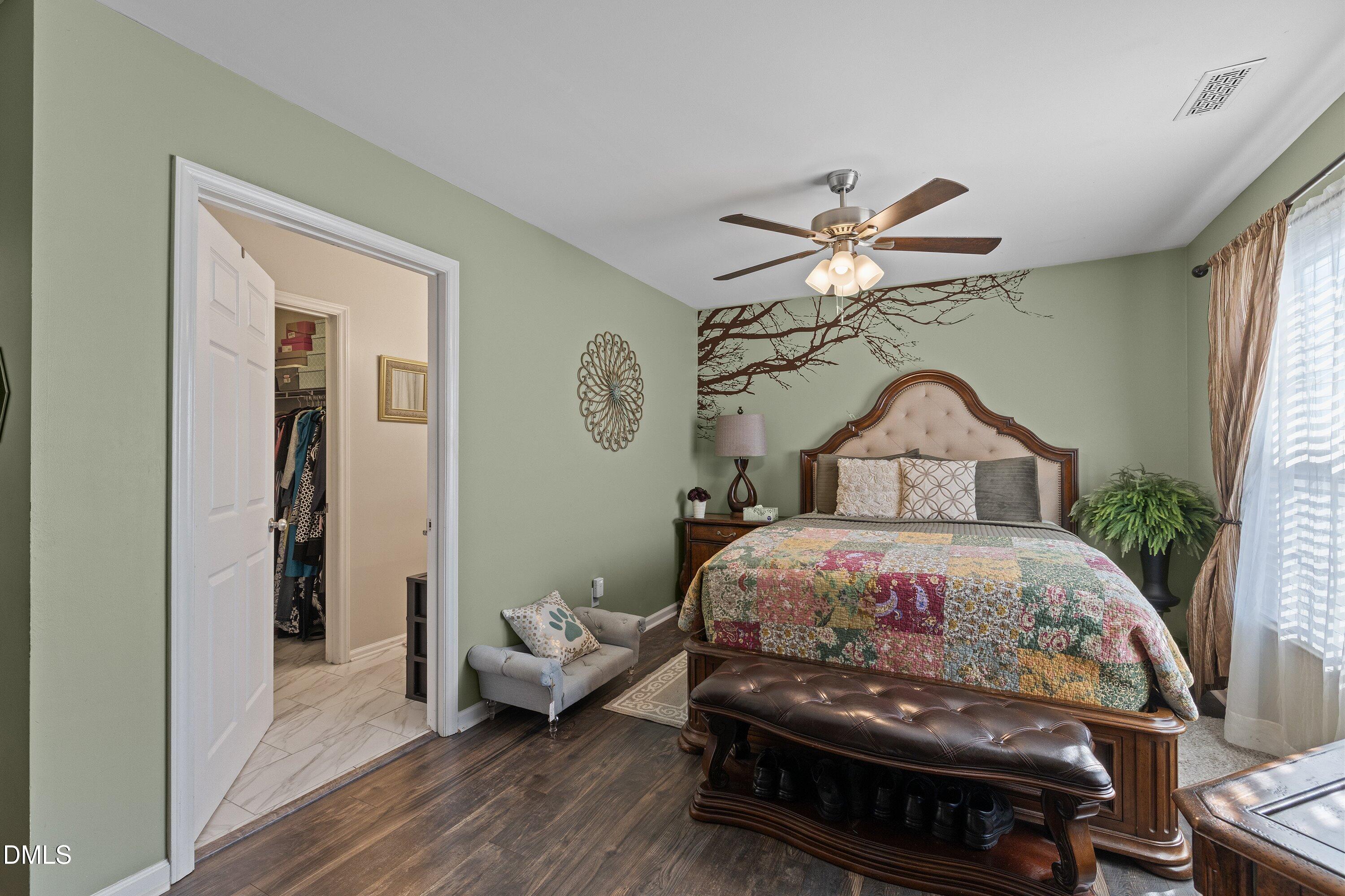 201 Dairy Road Clayton, NC 27520 - Photo 22 of 31 a bedroom with a bed and a chandelier
