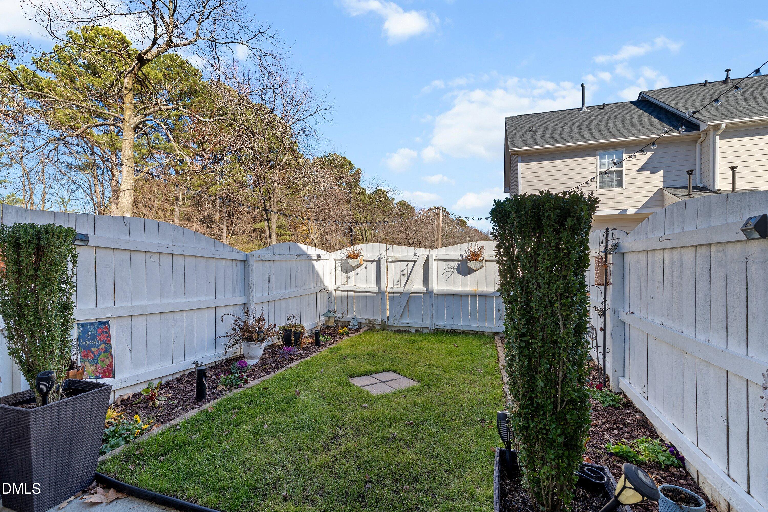 201 Dairy Road Clayton, NC 27520 - Photo 27 of 31 a view of a house with a backyard and plants