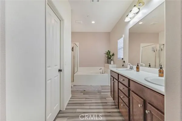 a spacious bathroom with a double vanity sink and a mirror