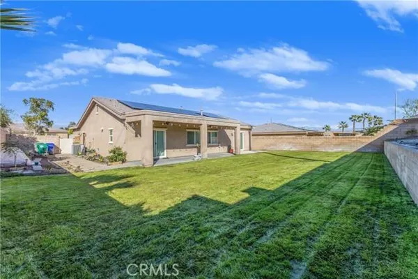 a view of a house with a yard and front view of a house