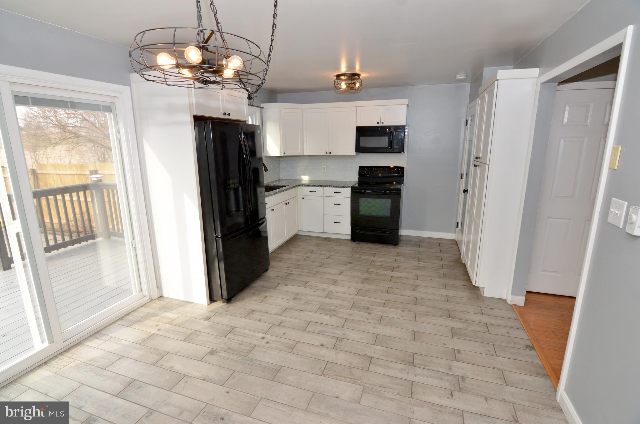116 Turnbridge Drive Lancaster, PA 17603 - Photo 15 of 41 a view of a kitchen with a sink and dishwasher refrigerator wooden floor and a kitchen