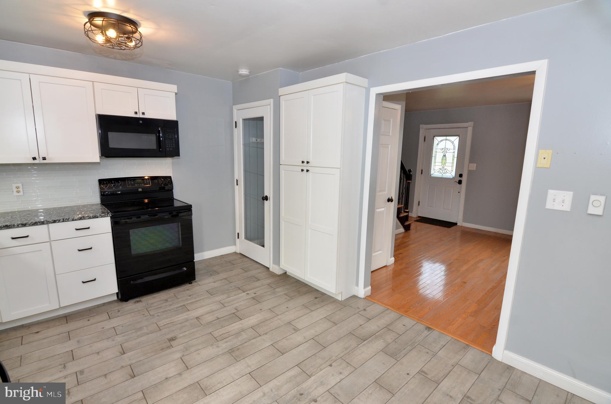 116 Turnbridge Drive Lancaster, PA 17603 - Photo 16 of 41 a view of a kitchen with white cabinets and black appliances