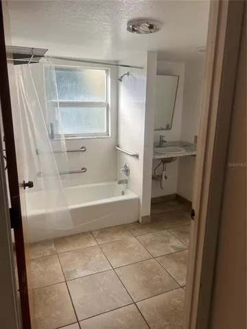 a bathroom with a bathtub and a shower