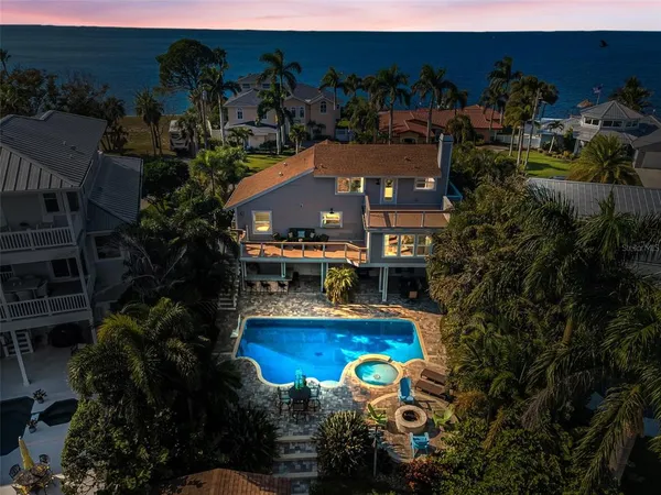 an aerial view of a house with a lake view