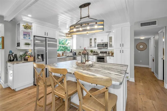 a view of an outdoor dining space with a table and chairs
