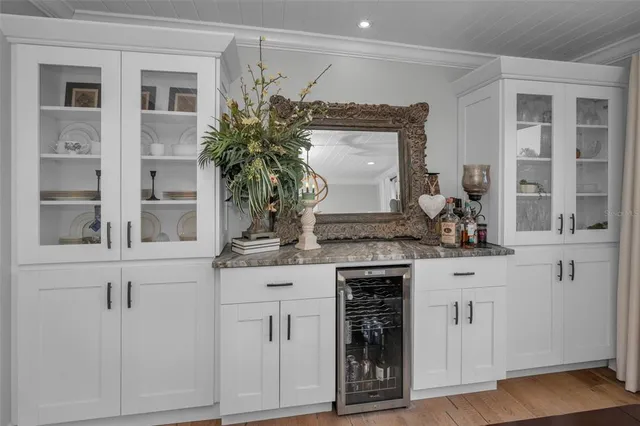 a view of a backyard with table and chairs and potted plants