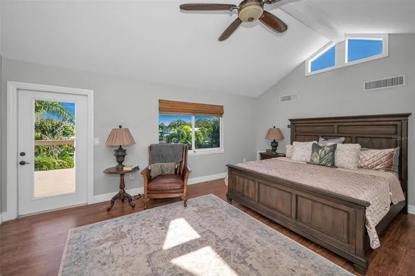 a bedroom with a bed and a chandelier