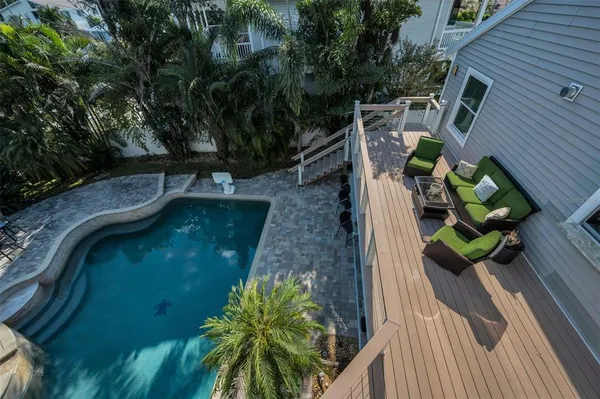 a view of a backyard with table and chairs and potted plants