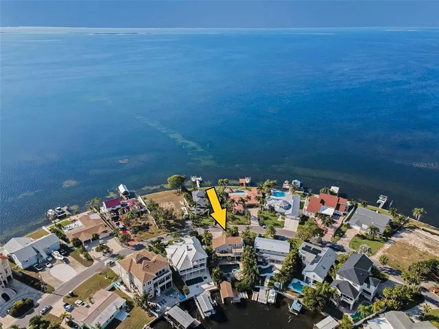 a kitchen with granite countertop a sink stainless steel appliances and cabinets