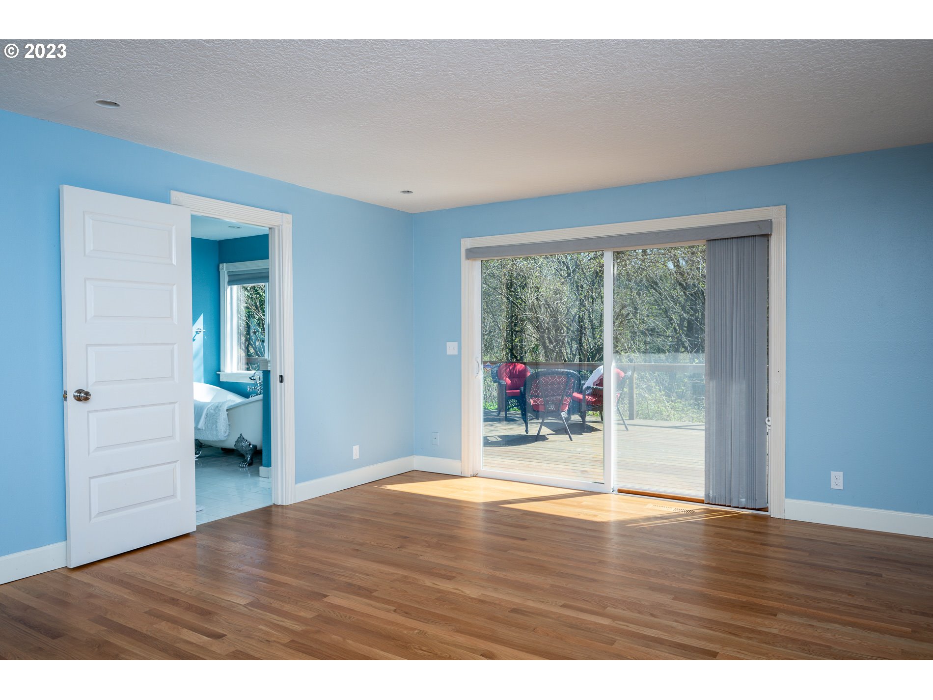 930 Northeast Salzman Road Corbett, OR 97019 - Photo 12 of 32 a view of an empty room with wooden floor and a window