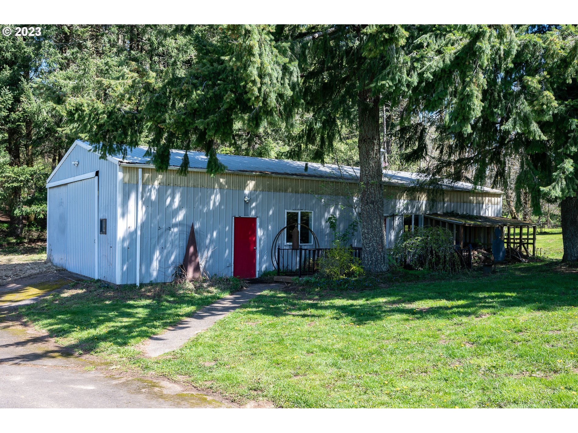930 Northeast Salzman Road Corbett, OR 97019 - Photo 21 of 32 a view of a house with a yard potted plants and a large tree