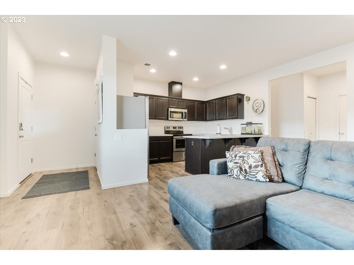 2375 Southeast 16th Street Gresham, OR 97080 - Photo 7 of 28 a living room with stainless steel appliances kitchen island granite countertop furniture and a view of kitchen