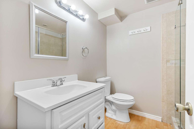 415 East 1150th Street North Logan, UT 84341 - Photo 28 of 38 Bathroom featuring a white vanity with integrated sink, chrome faucet, framed mirror, and a wall-mounted light fixture