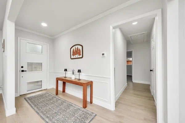 a dining room with wooden floor and a table