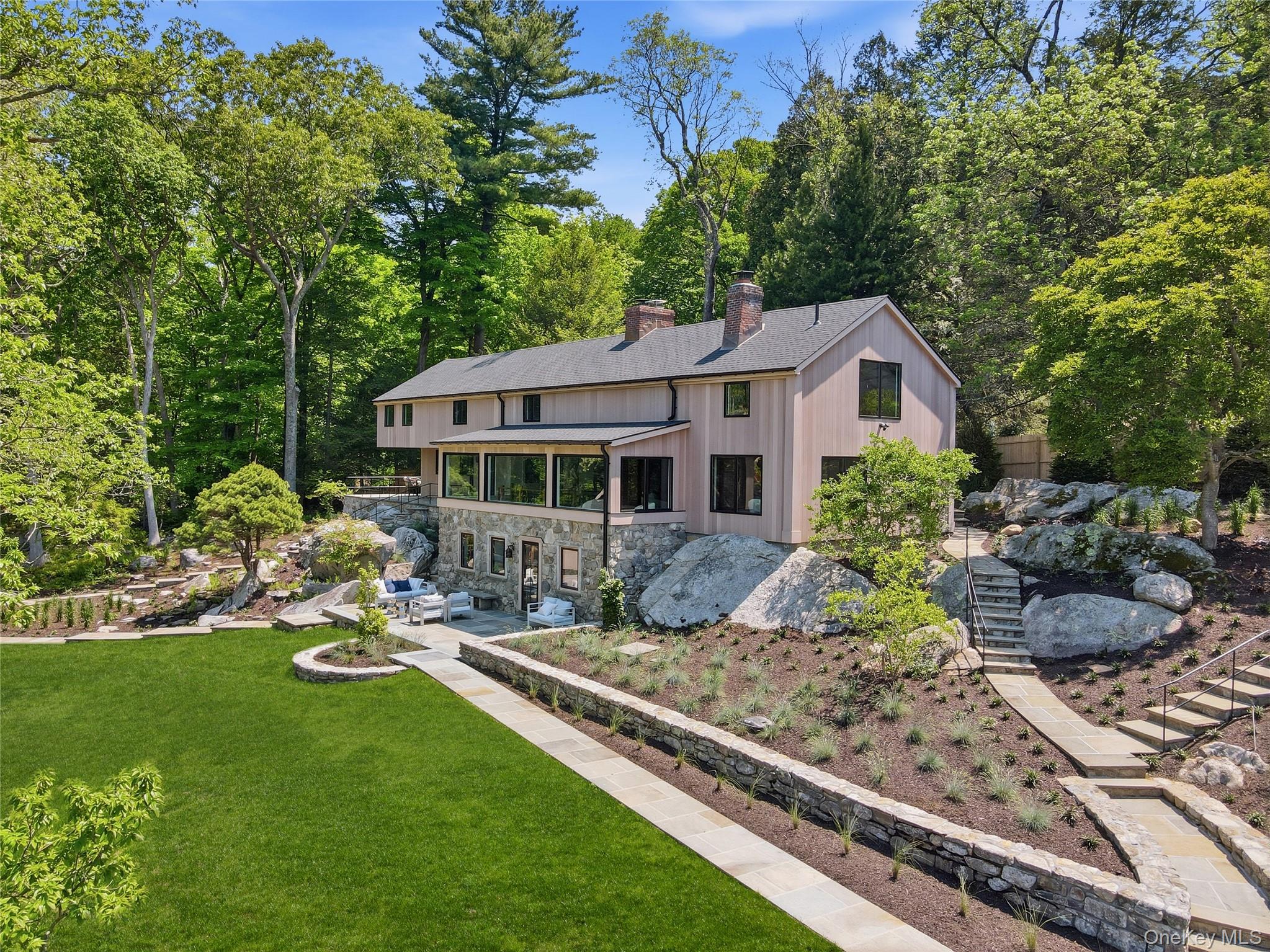 39 Old Snake Hill Road Pound Ridge, NY 10576 - Photo 31 of 37 a view of a house with backyard sitting area and garden