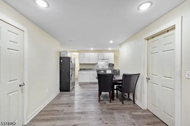 a kitchen with stainless steel appliances granite countertop a refrigerator a stove a sink and a refrigerator