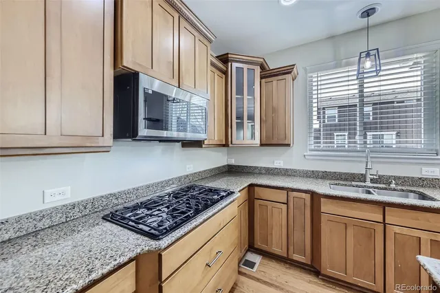 a kitchen with stainless steel appliances granite countertop a sink stove and cabinets