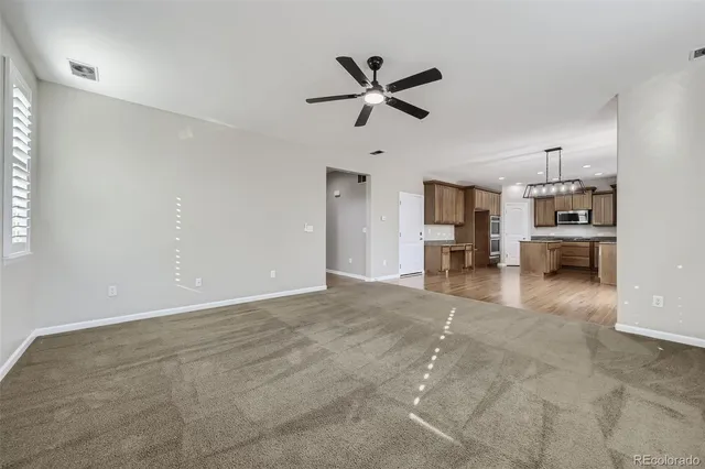 a view of livingroom with hardwood floor and a ceiling fan