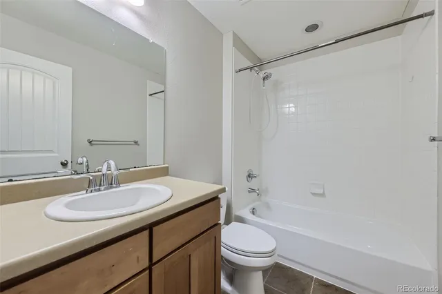 a bathroom with a sink toilet vanity and shower