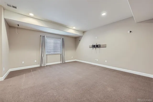 an empty room with a empty space and windows