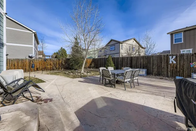 a view of a patio with a table and chairs