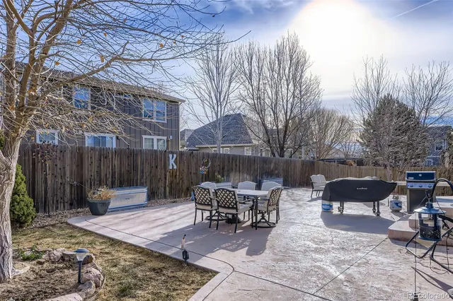 a patio with a table and chairs