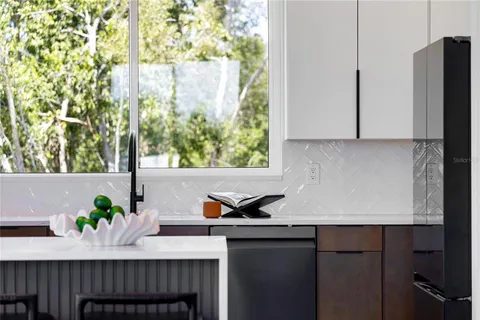 a kitchen with a sink a microwave and cabinets