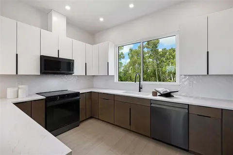 a kitchen with stainless steel appliances a sink stove and microwave